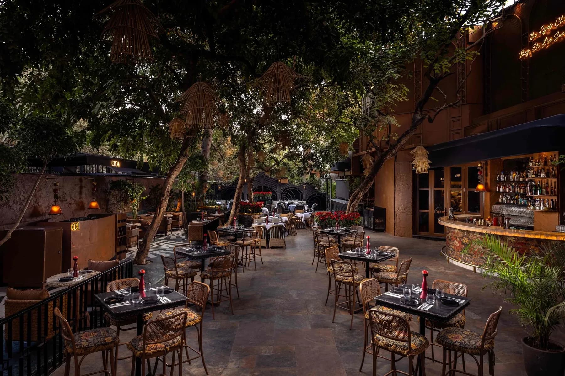 Chica's Fountain Court — lantern-lit courtyard dining beneath sculpted foliage